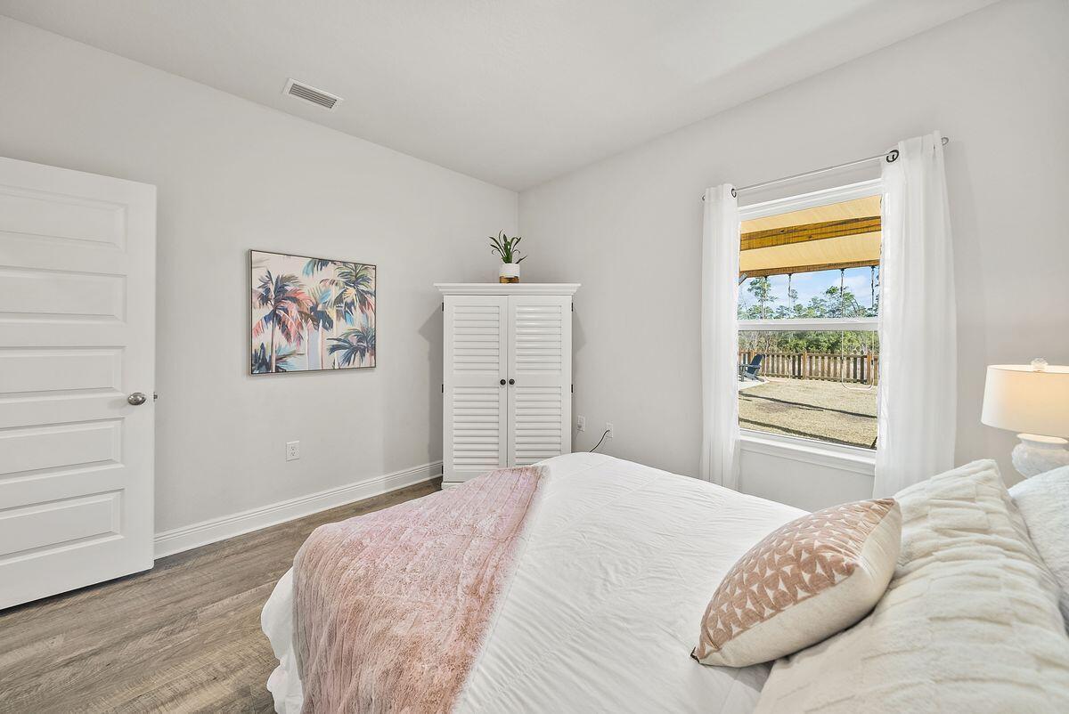 774 Backwater Road Port St. Joe, FL 32456 - Photo 26 of 65 a bedroom with a bed and a window