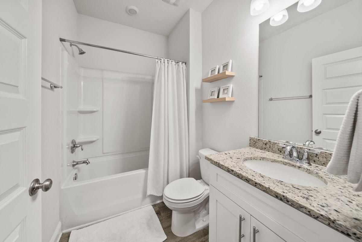 774 Backwater Road Port St. Joe, FL 32456 - Photo 27 of 65 a bathroom with a granite countertop sink toilet and shower