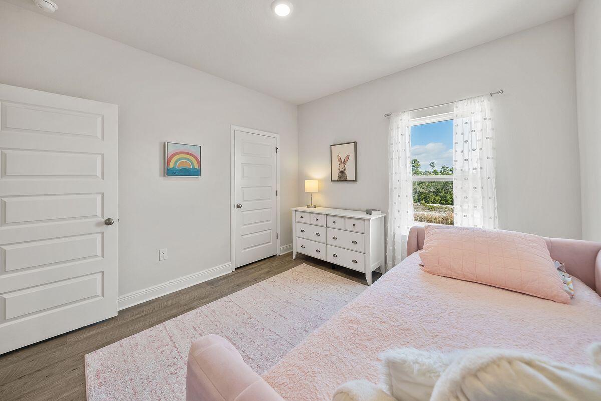 774 Backwater Road Port St. Joe, FL 32456 - Photo 29 of 65 a bedroom with a bed lamp and a window