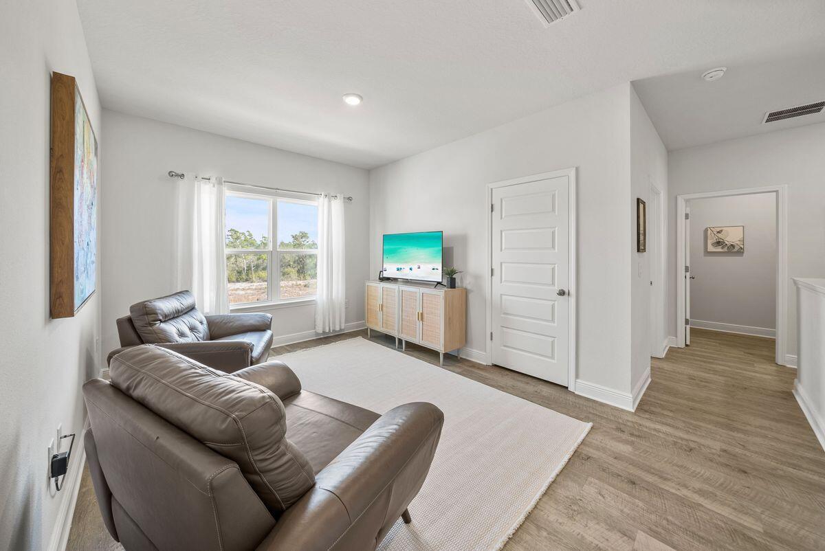 774 Backwater Road Port St. Joe, FL 32456 - Photo 30 of 65 a living room with furniture and a large window