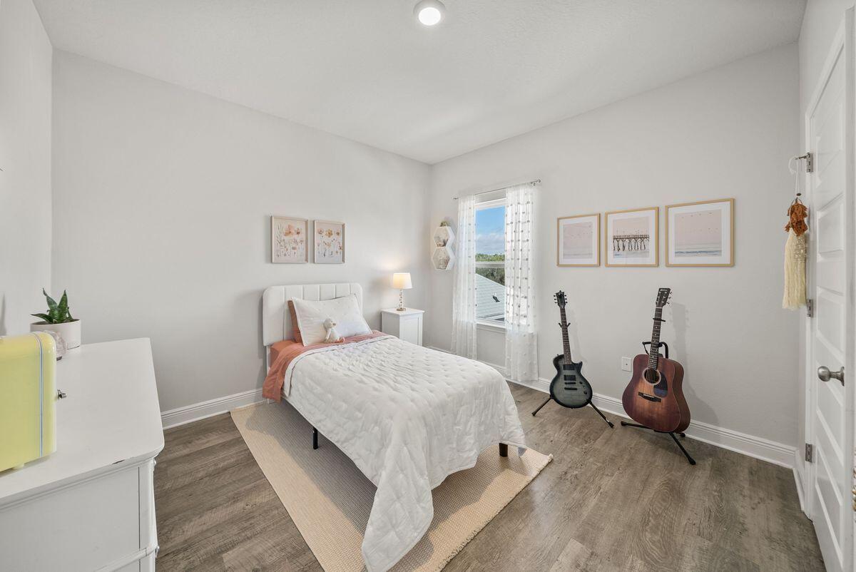 774 Backwater Road Port St. Joe, FL 32456 - Photo 32 of 65 a bedroom with a bed and wooden floor