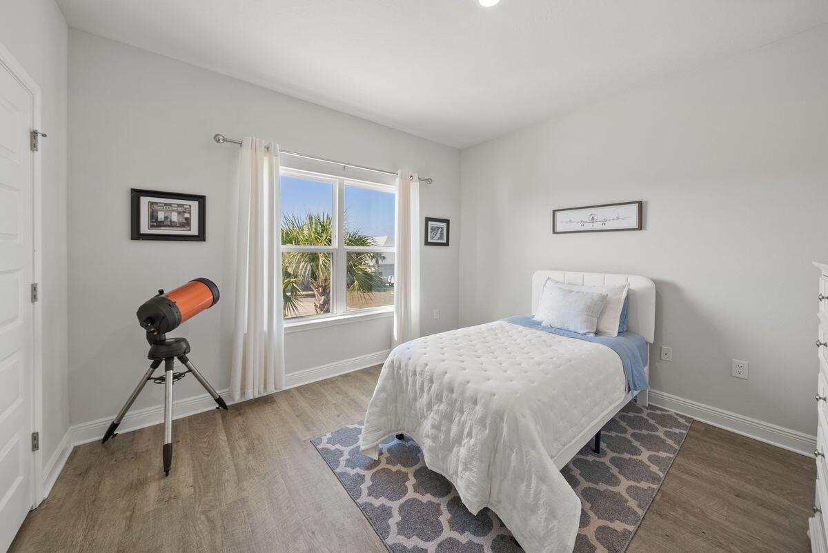 774 Backwater Road Port St. Joe, FL 32456 - Photo 36 of 65 a bedroom with a bed and a table in it