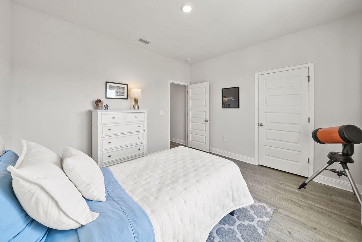 774 Backwater Road Port St. Joe, FL 32456 - Photo 37 of 65 a bedroom with a bed and chair