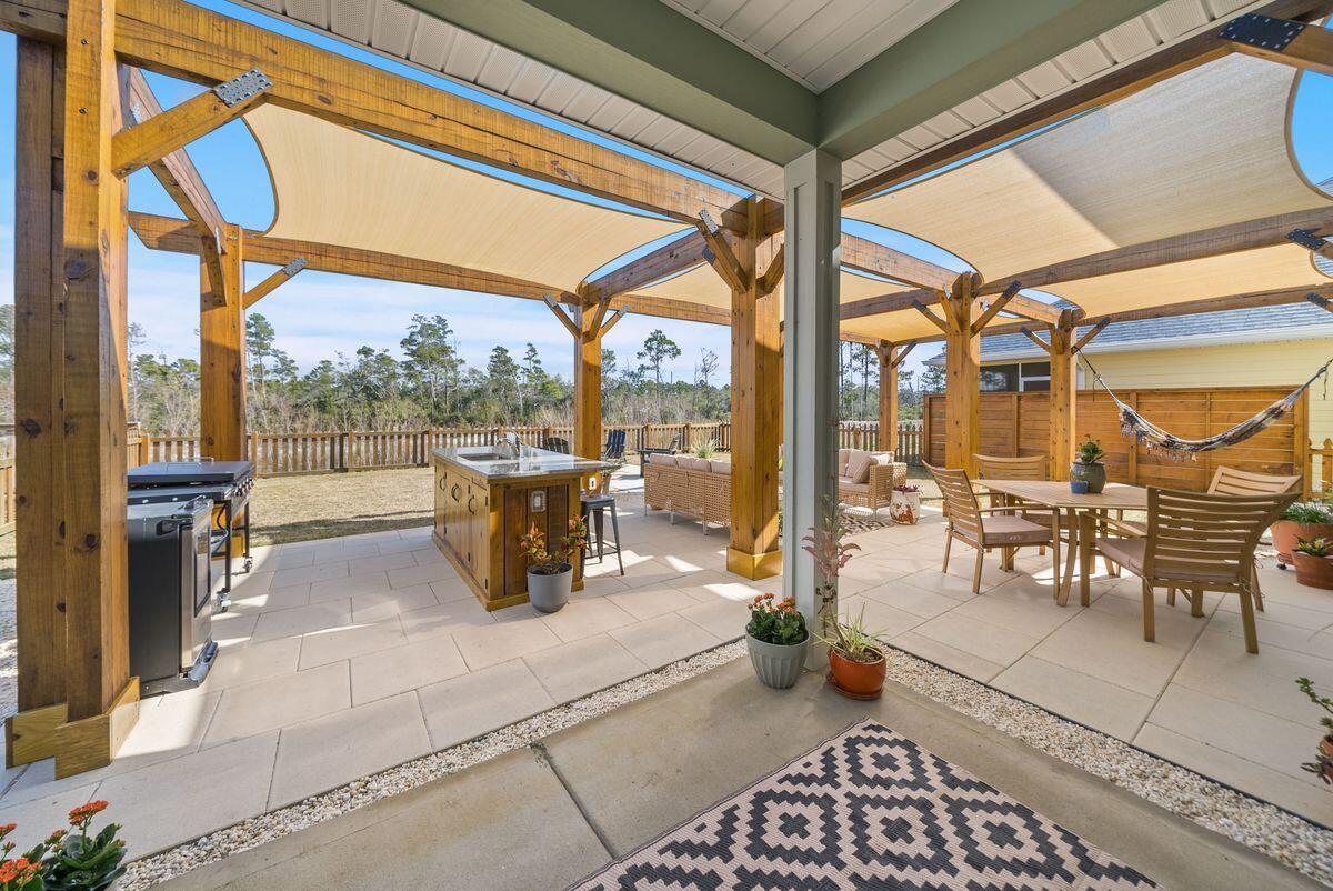 774 Backwater Road Port St. Joe, FL 32456 - Photo 39 of 65 a view of a patio with a dining table and chairs