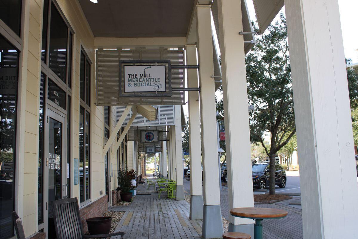 774 Backwater Road Port St. Joe, FL 32456 - Photo 59 of 65 a view of a house with a potted plant and floor to ceiling windows