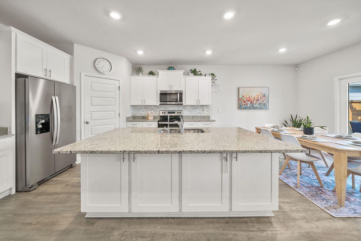 774 Backwater Road Port St. Joe, FL 32456 - Photo 10 of 65 a kitchen with stainless steel appliances granite countertop a sink stove and refrigerator