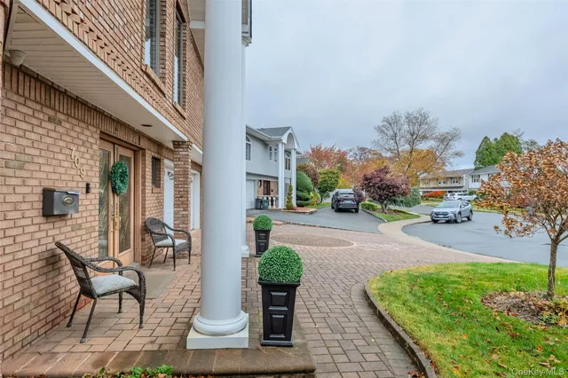 a front view of a house with garden and patio