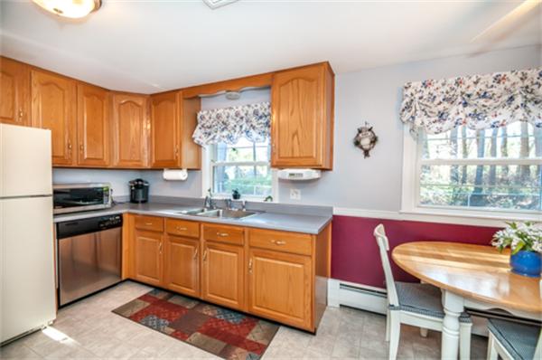 34 Rangeway Road Billerica, MA 01862 - Photo 8 of 30 a kitchen with stainless steel appliances wooden cabinets a stove a sink and a window