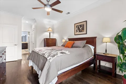 a bedroom with bed and a chandelier