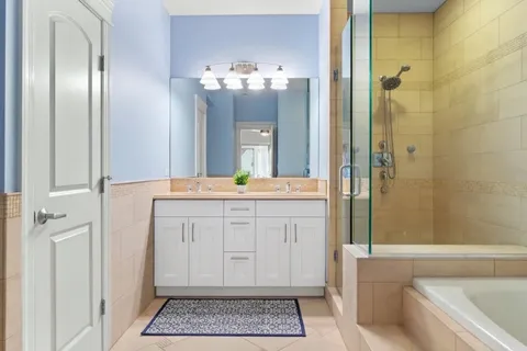 a bathroom with a granite countertop sink a toilet and shower