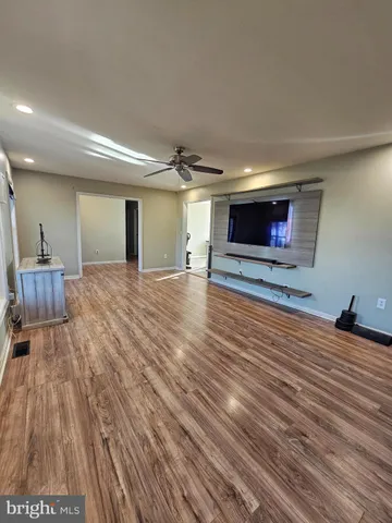 a view of a room with wooden floor and chair