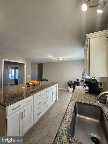 a kitchen with granite countertop a sink and a granite counter tops