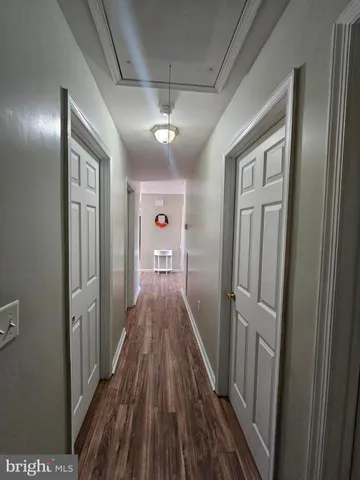 a view of a hallway with wooden floor