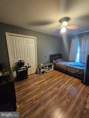 a living room with furniture gym equipment and a window