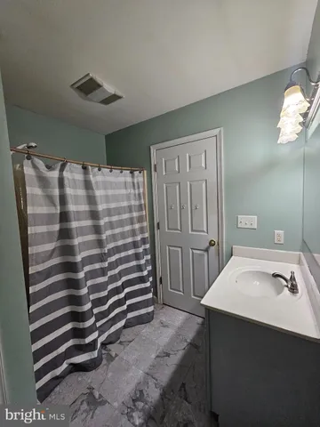 a white toilet sitting next to a bathroom sink