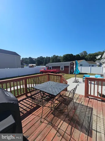 a view of house with a yard and patio