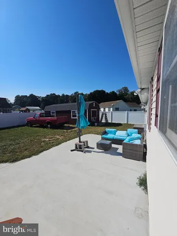a front view of a house with a yard table and chairs