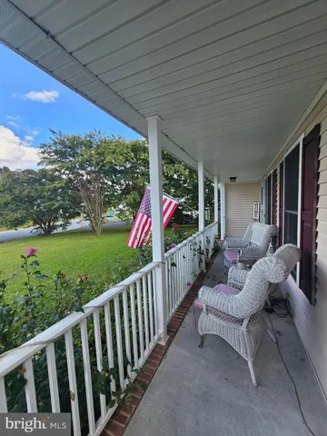 a view of a porch with furniture and yard