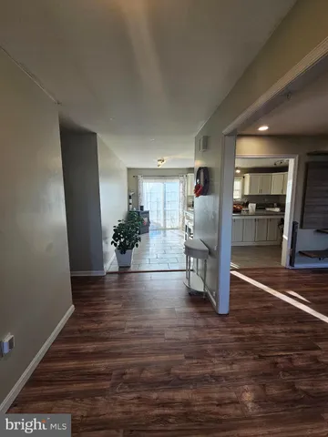 a view of kitchen and hall with wooden floor