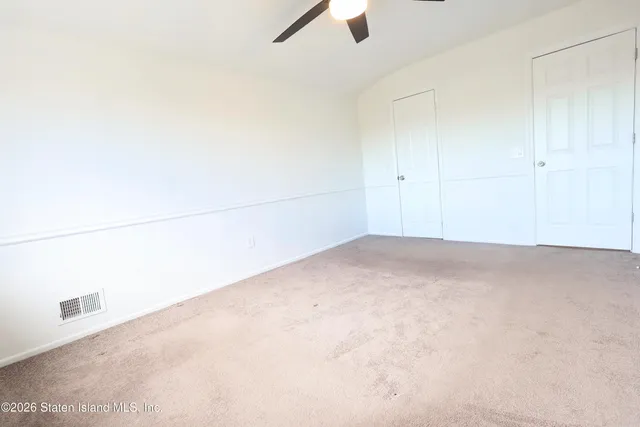 a bedroom with a bed and a potted plant