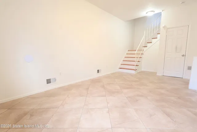 a view of an empty room with stairs