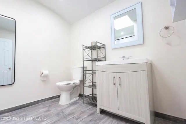 a bathroom with a toilet sink and mirror