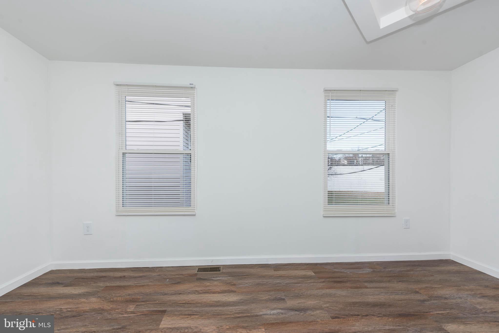 554 Gold Street Baltimore, MD 21217 - Photo 15 of 23 an empty room with wooden floor and windows