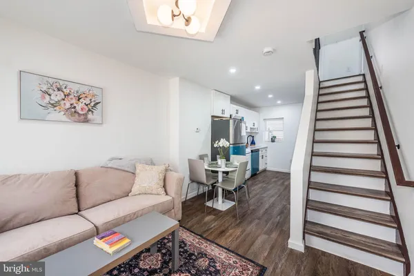 a living room with furniture and wooden floor