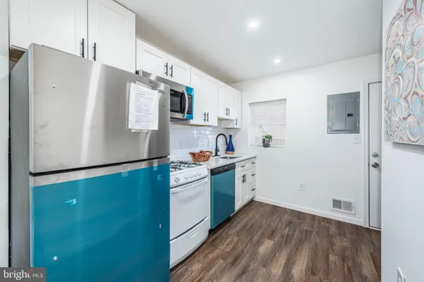 a kitchen with stainless steel appliances a refrigerator sink and microwave