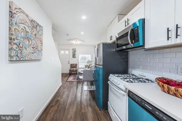 a kitchen with a sink cabinets and wooden floor