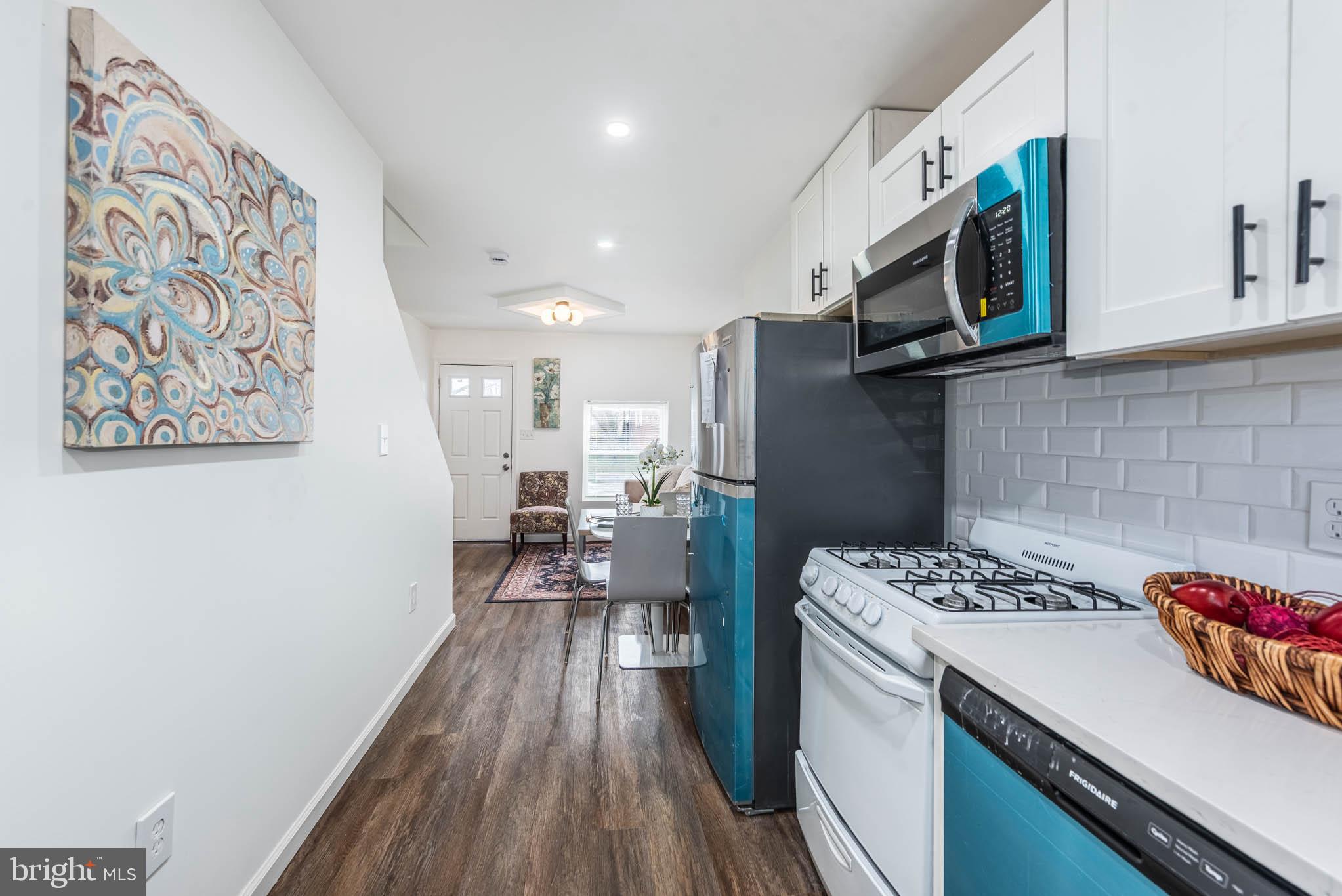 554 Gold Street Baltimore, MD 21217 - Photo 9 of 23 a kitchen with a sink cabinets and wooden floor
