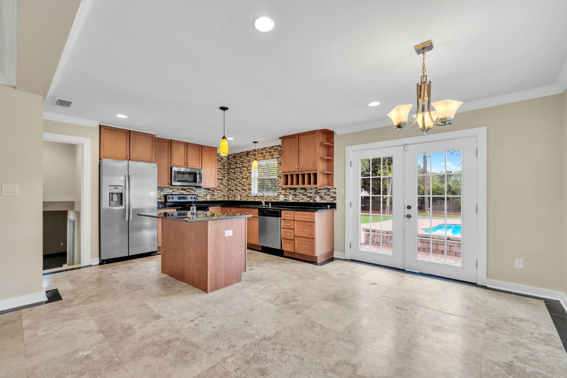 536 Benning Drive Destin, FL 32541 - Photo 11 of 46 a kitchen with stainless steel appliances a refrigerator a stove a sink dishwasher with a dining table and chairs