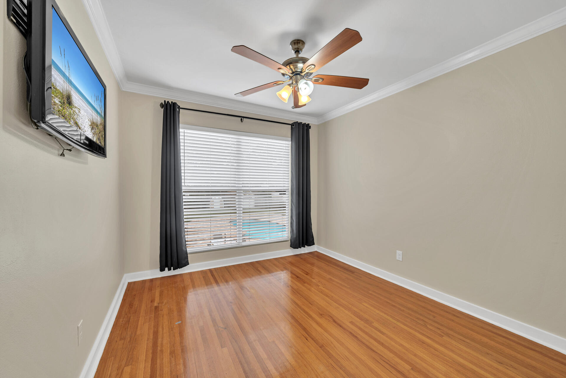 536 Benning Drive Destin, FL 32541 - Photo 25 of 46 a view of an empty room with wooden floor and a window