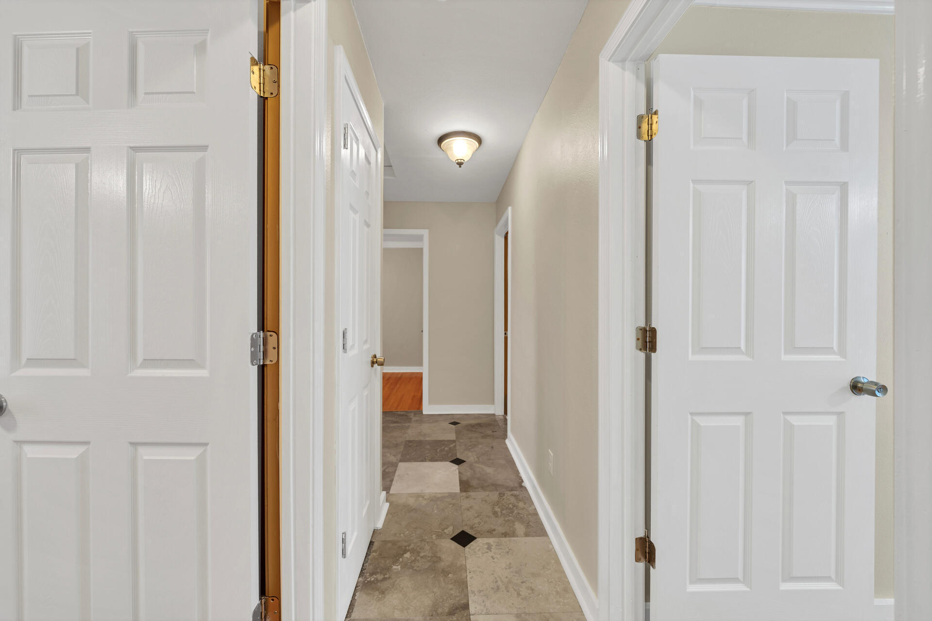 536 Benning Drive Destin, FL 32541 - Photo 28 of 46 a view of a hallway with wooden floor and closet area
