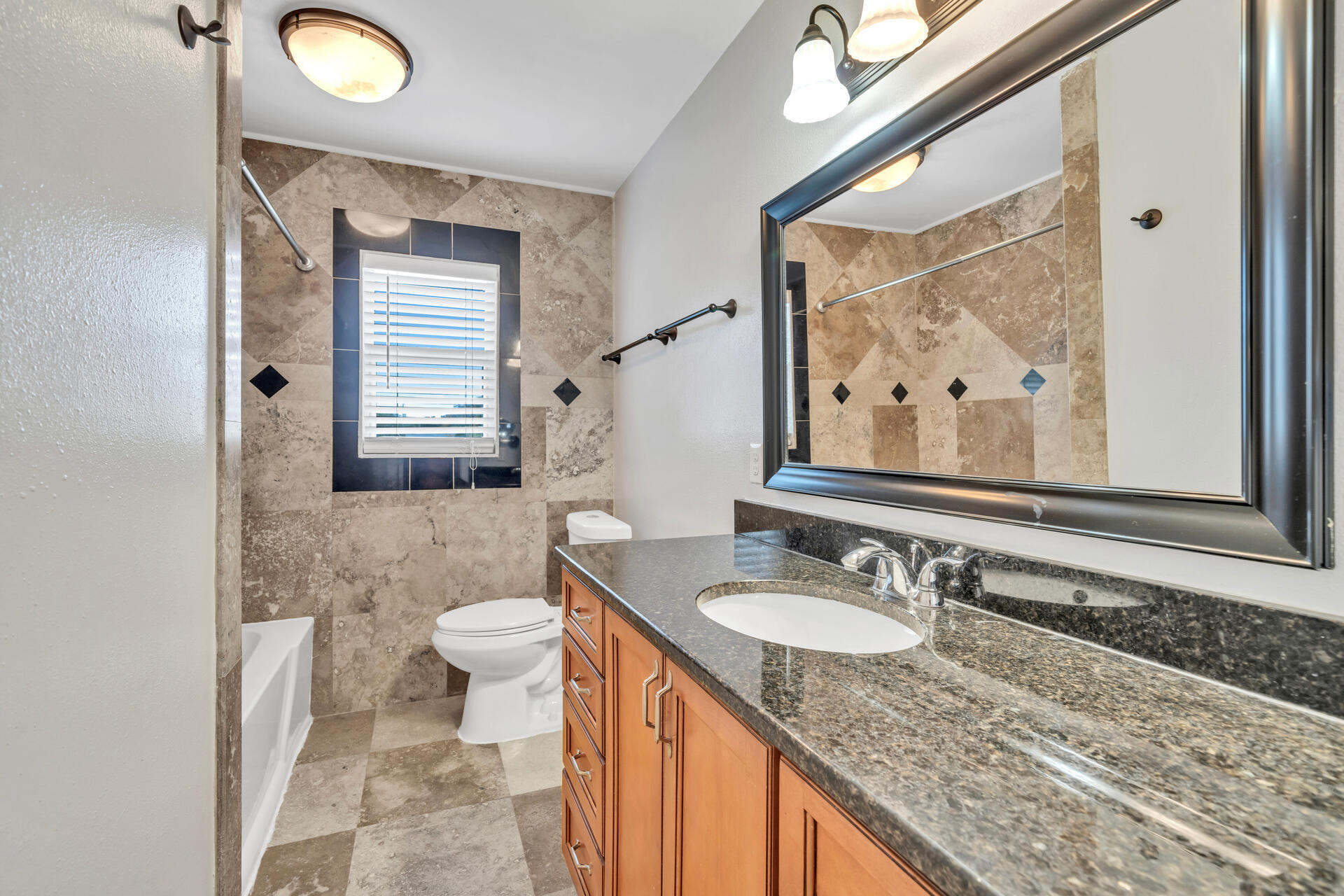536 Benning Drive Destin, FL 32541 - Photo 36 of 46 a bathroom with a granite countertop sink a toilet and a mirror