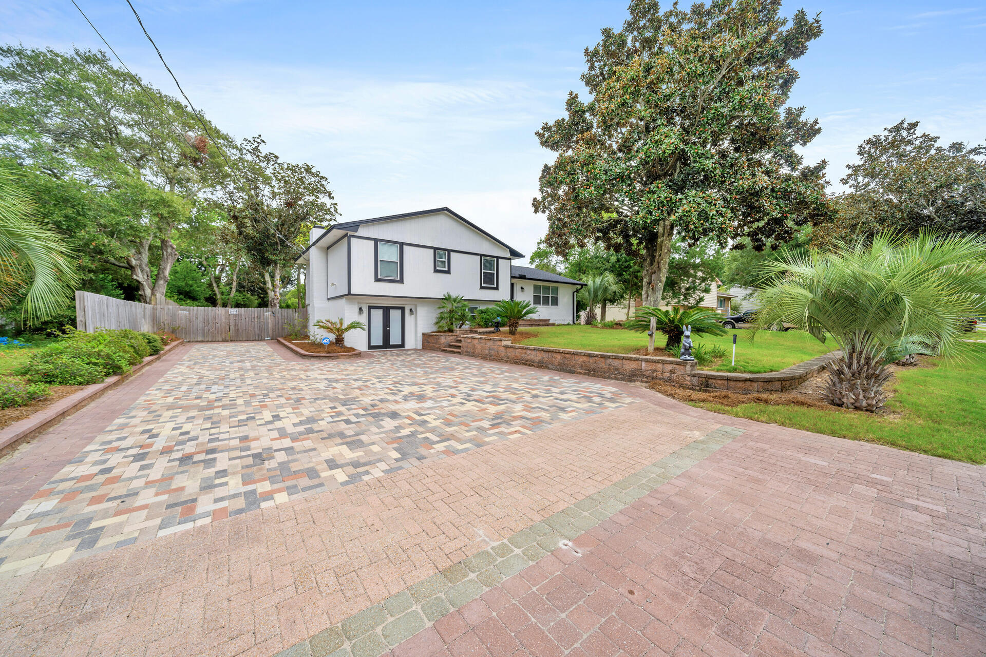 536 Benning Drive Destin, FL 32541 - Photo 4 of 46 a front view of a house with a yard and pathway