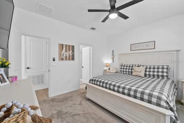 a bathroom with a granite countertop toilet sink and mirror