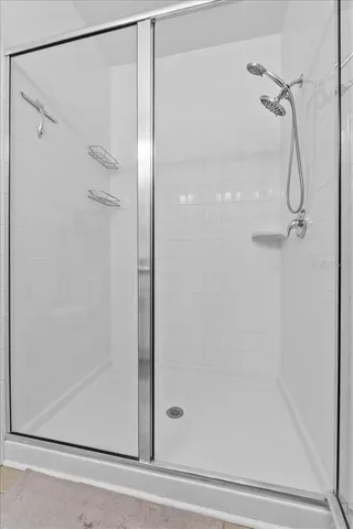 a walk in closet with clothes and shoes