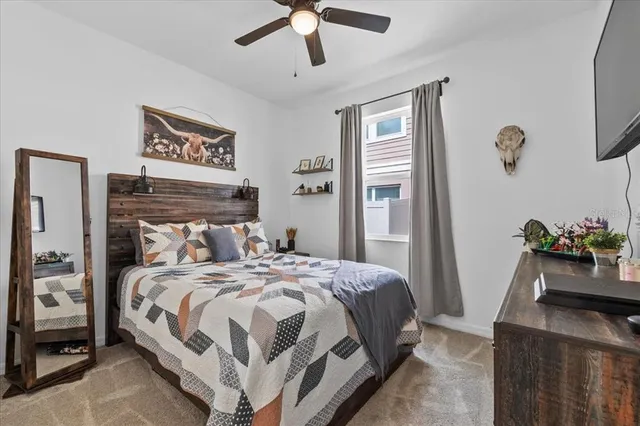 a bedroom with a bed and a flat tv screen