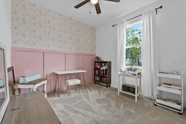 a spacious bedroom with a bed and a table in it