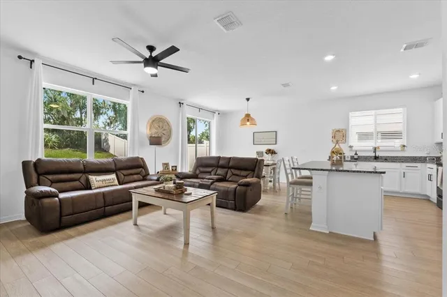 a living room with fireplace furniture and a large window