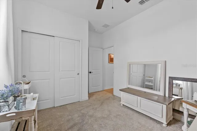 a bathroom with a granite countertop sink mirror and toilet