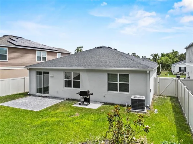 a backyard of a house with table and chairs
