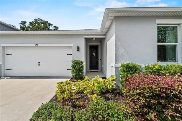 a view of a house with a yard and sitting area