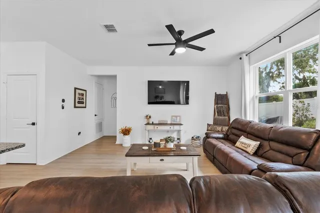 a living room with furniture a large window and a flat screen tv