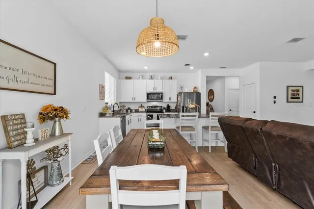 a view of a dining room with furniture and wooden floor