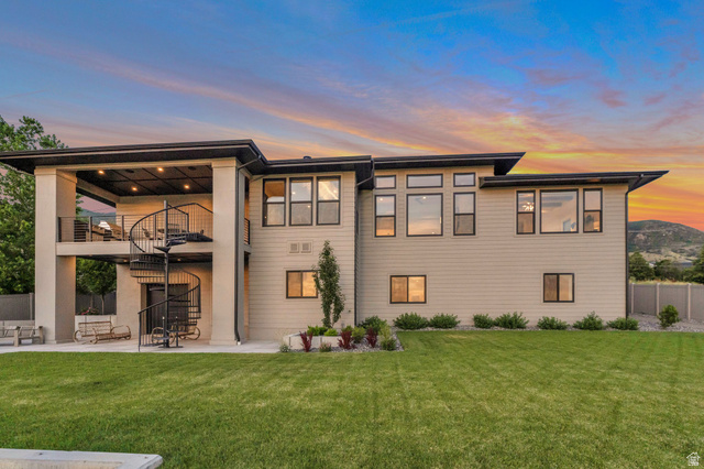 2145 North Main Street Centerville, UT 84014 - Photo 3 of 53 Back of house at dusk featuring a balcony and a patio area