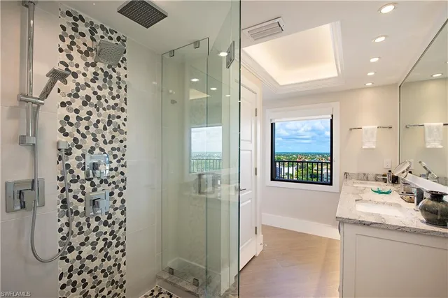 a bathroom with a shower sink and mirror
