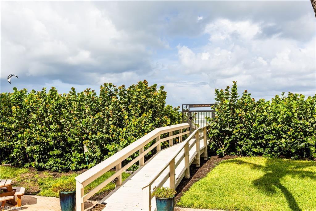 850 South Collier Boulevard, Unit 1103 Marco Island, FL 34145 - Photo 16 of 24 a view of a swimming pool with a yard and seating area