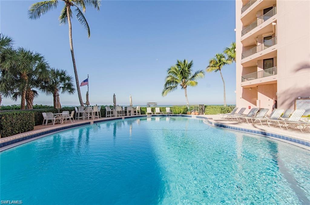 850 South Collier Boulevard, Unit 1103 Marco Island, FL 34145 - Photo 21 of 24 a view of a swimming pool with a table and chairs